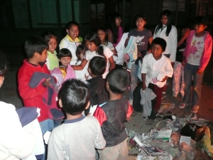 The children handing out food and clothes at the local market.